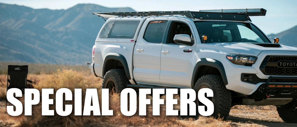 A white Toyota pick-up truck with a LEER truck cap with text overlay that reads SPECIAL OFFERS